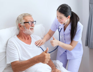 nurse and senior man doing thumbs up