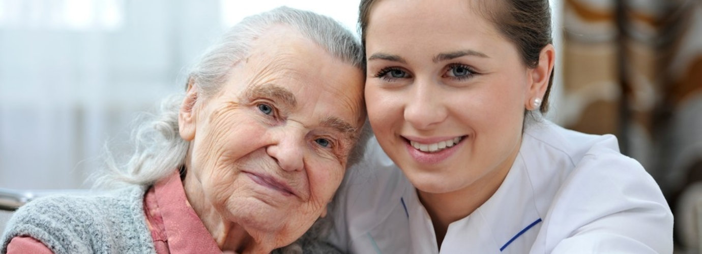 caregiver and senior woman smiling