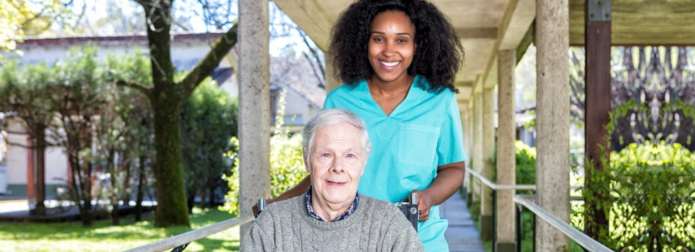 caregiver and senior man smiling